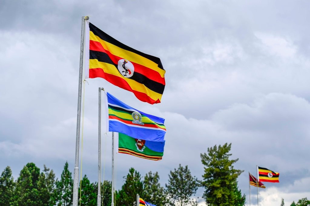 Uganda flag and East African flag fly on flagpost - Nandi Adventures
