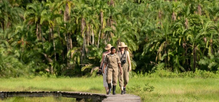 Women on a nature walk during a safari in Uganda - Nandi Adventures