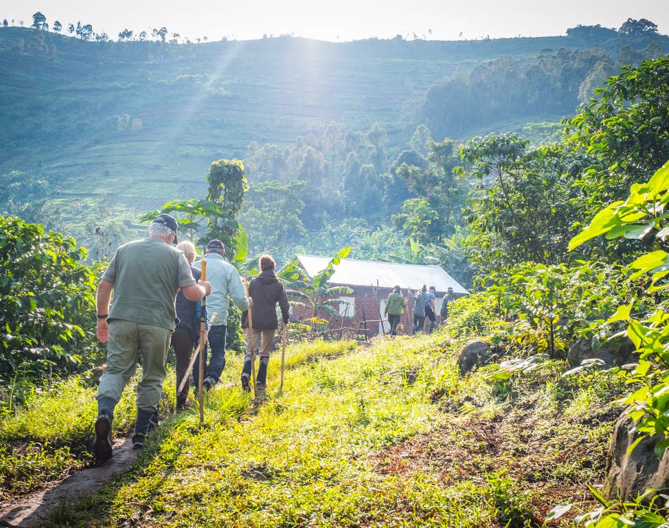 people and gorillas conservation bwindi 4 | Nandi Adventures Uganda Safari Tourists starting the long hike into Bwindi Impenetrable National Park for one of the daily gorilla tracking tours. Buhoma, Uganda. Nandi Adventures